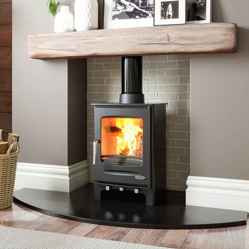 Henley Sherwood multi-fuel stove burning brightly in an elegant white traditional fireplace with a large viewing window, Cork, Homexpert